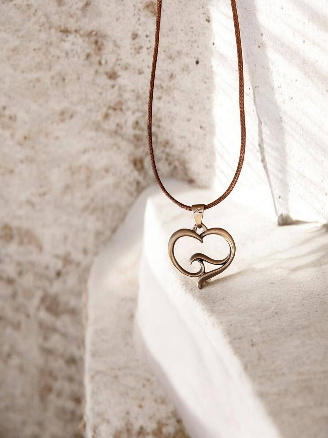 Roland St John ocean wave heart bronze pendant close-up